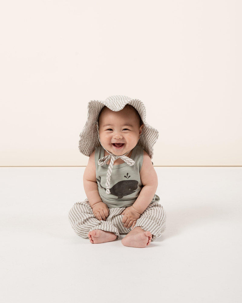 Baby in Olive Stripe Harem pant, floppy sun hat, and Rylee + Cru whale tank
